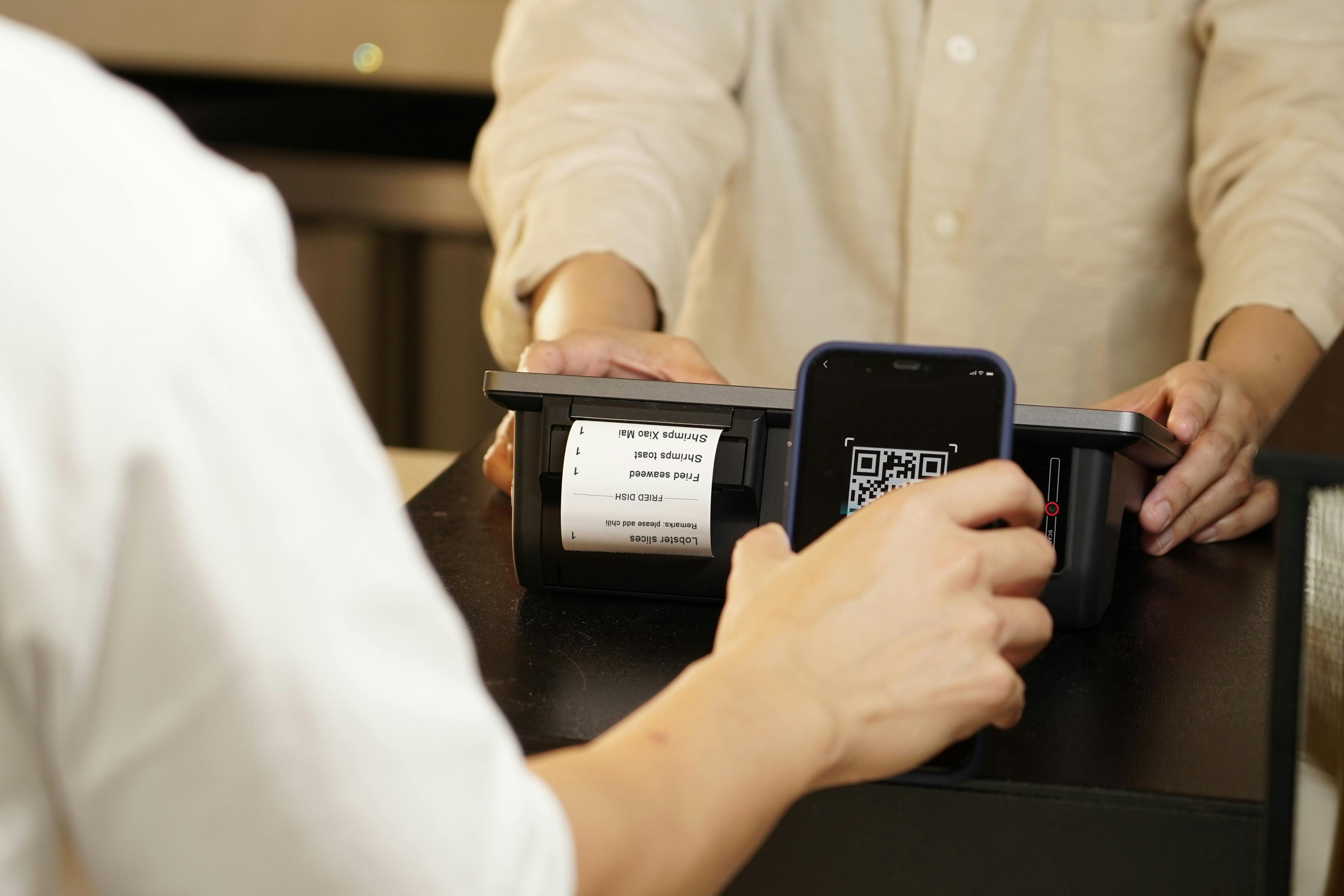 Customer paying with a QR code on a mobile POS